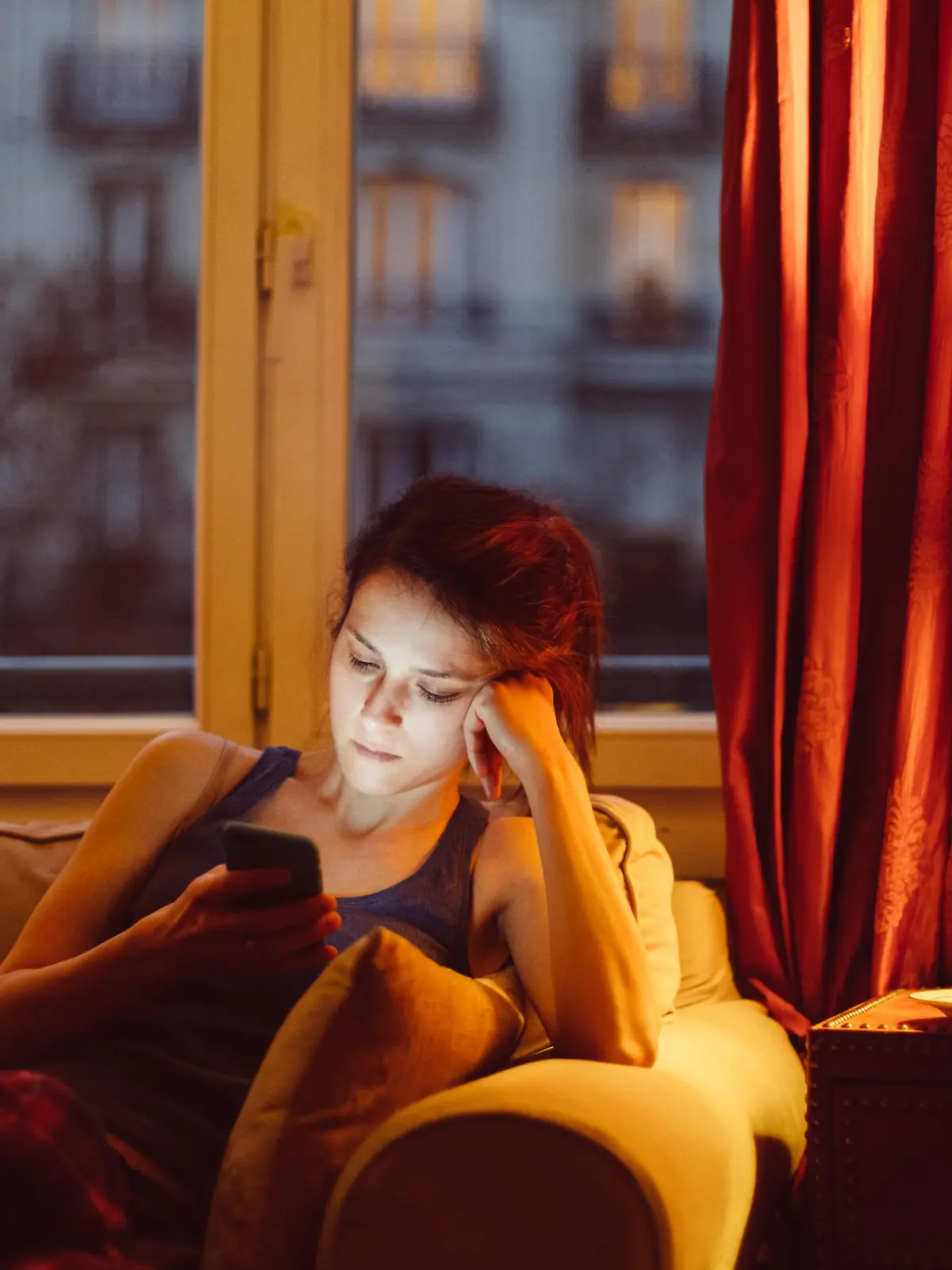 Unhappy woman at home text messaging