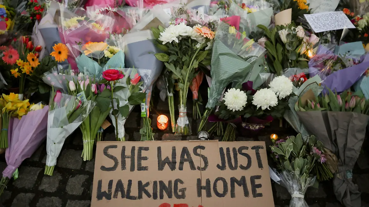A sign is seen as people gather at a memorial site in Clapham Common Bandstand, following the kidnap and murder of Sarah Everard, in London, Britain March 13, 2021. REUTERS/Hannah McKay TPX IMAGES OF THE DAY