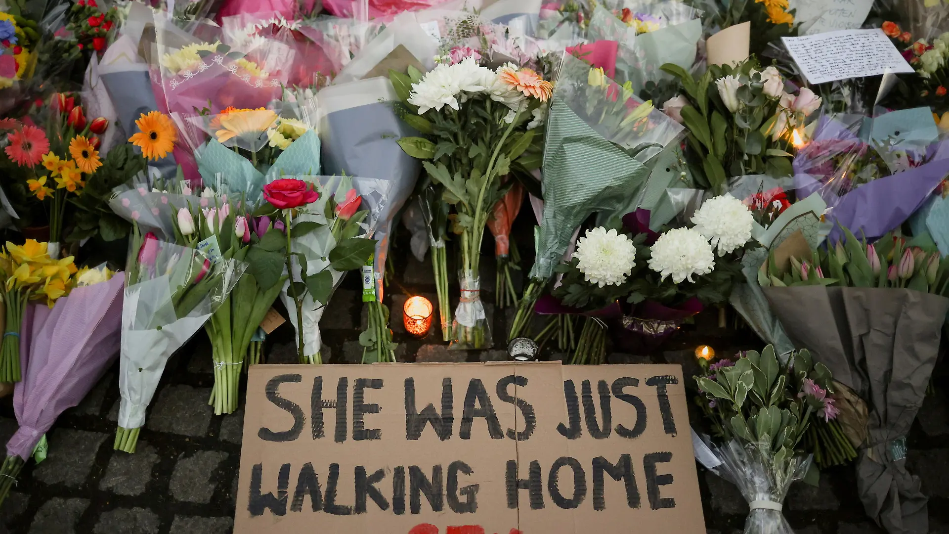 A sign is seen as people gather at a memorial site in Clapham Common Bandstand, following the kidnap and murder of Sarah Everard, in London, Britain March 13, 2021. REUTERS/Hannah McKay     TPX IMAGES OF THE DAY