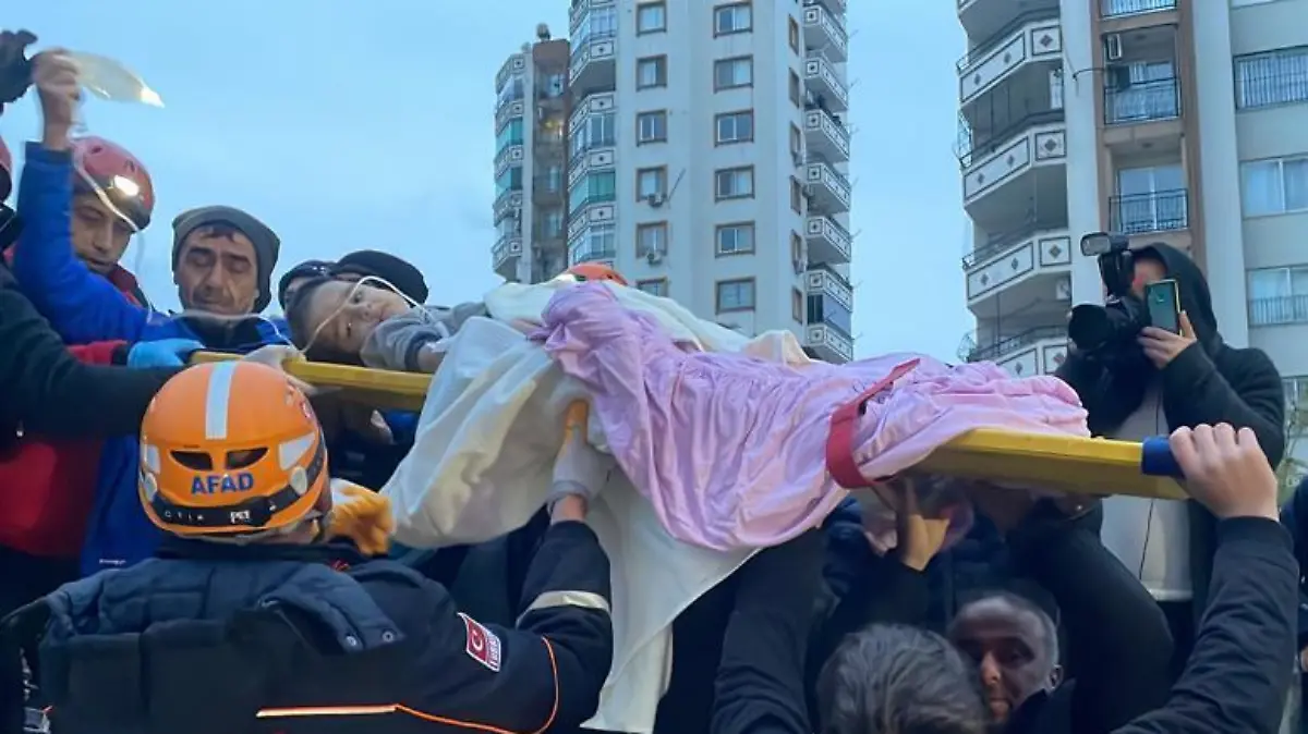 ADANA, TURKIYE - FEBRUARY 06: A child is rescued under the rubble of a collapsed building after 7.4 magnitude earthquake hits Adana, Turkiye on February 06, 2023. Fikret Kavgali / Anadolu Agency