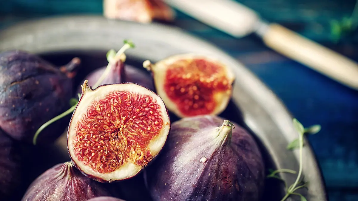 Figs and Sweet Honey on Wooden Background