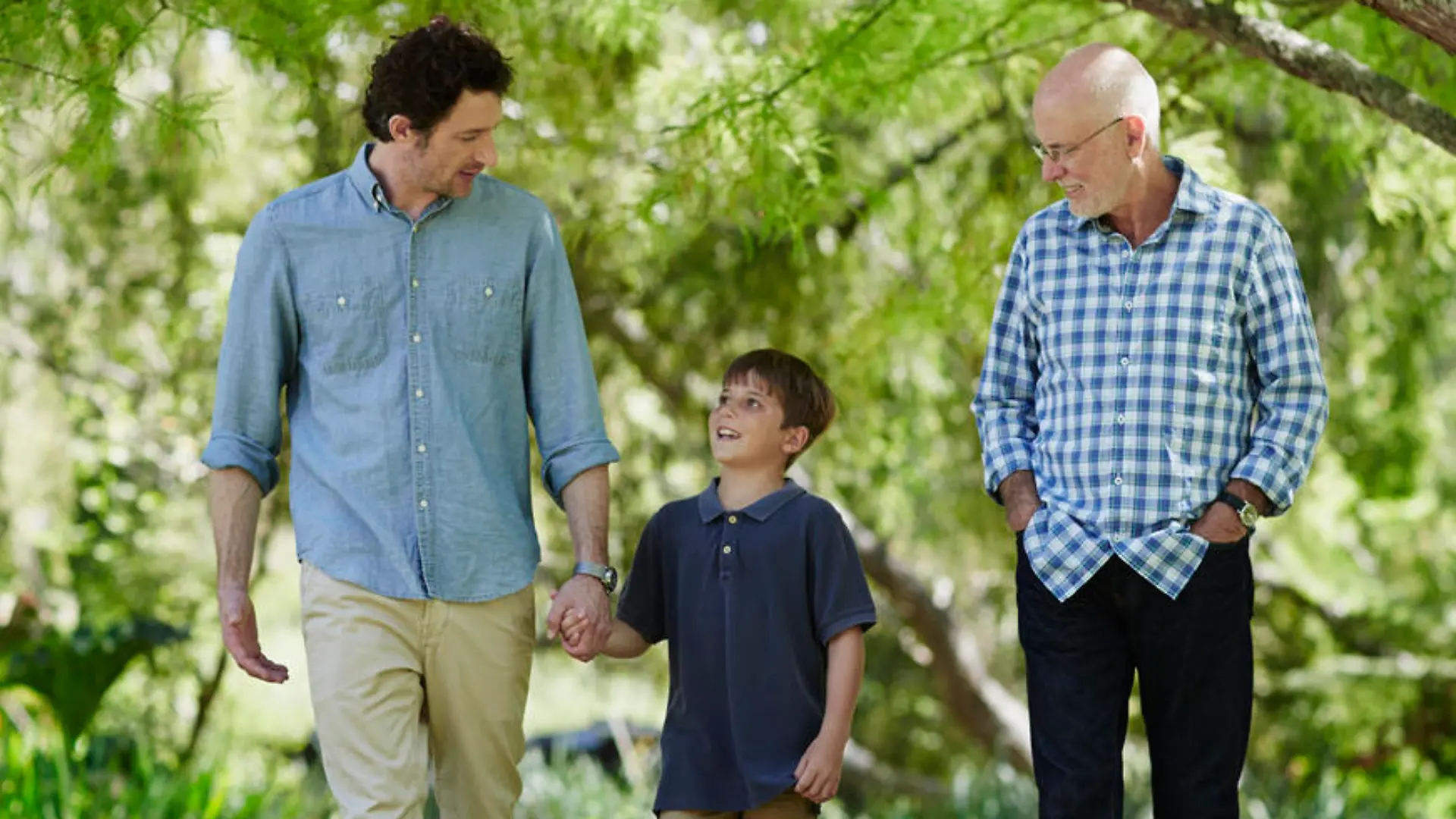 Full length of three generation males walking together in park