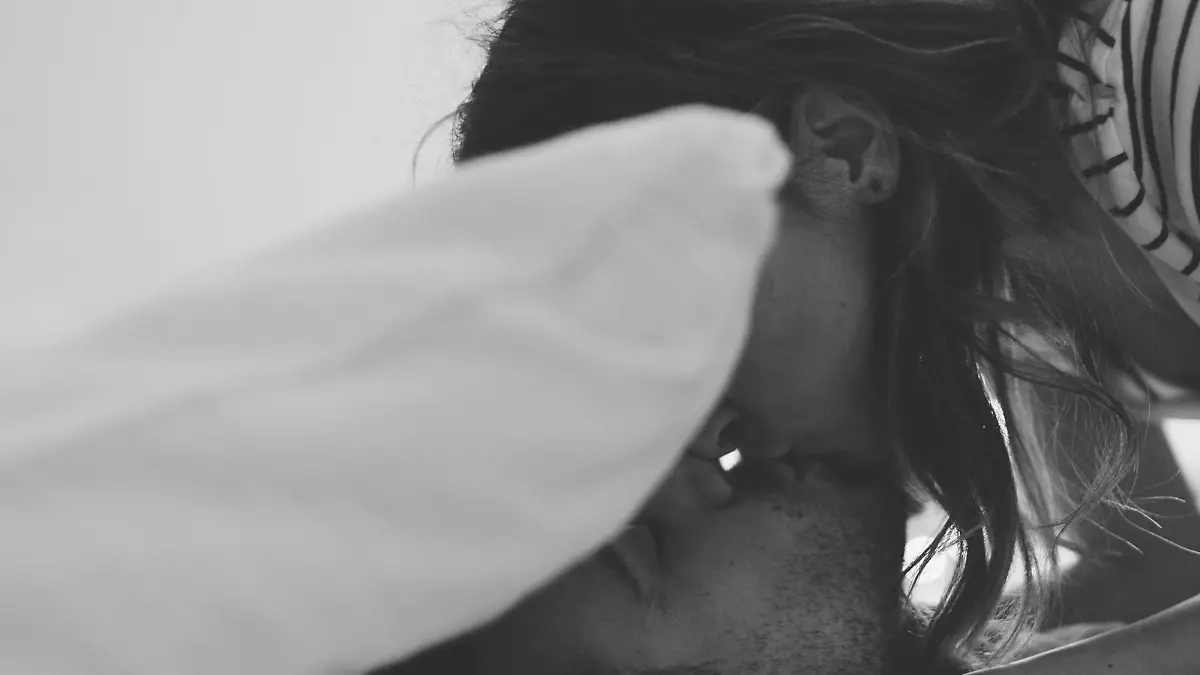 Lovely couple in pyjamas is getting ready for a good night sleep sealed with a kiss