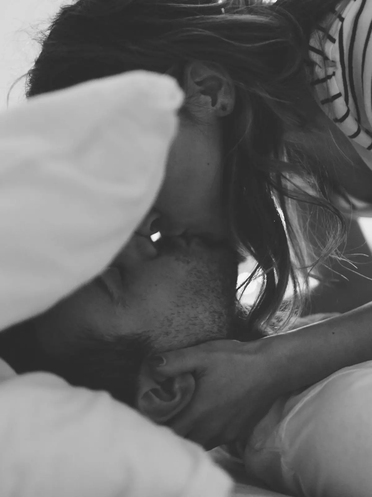 Lovely couple in pyjamas is getting ready for a good night sleep sealed with a kiss