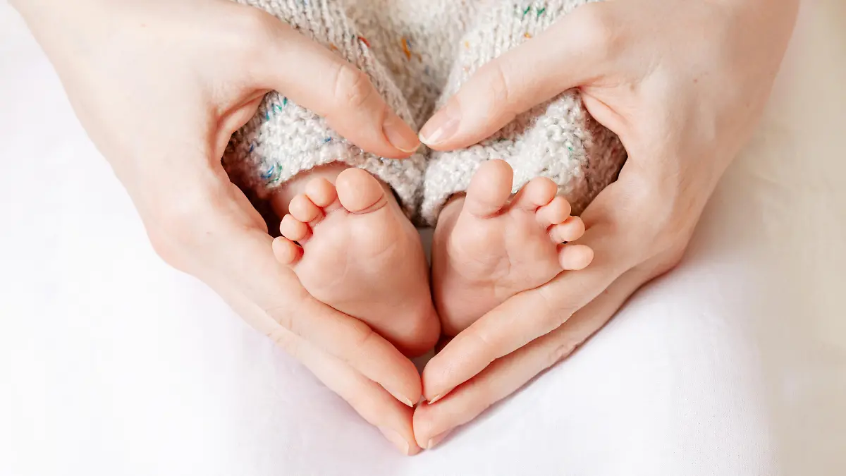 Baby Füße in den Händen der Mutter