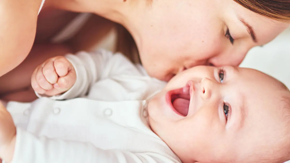 Shot of an adorable baby boy bonding with his mother at home