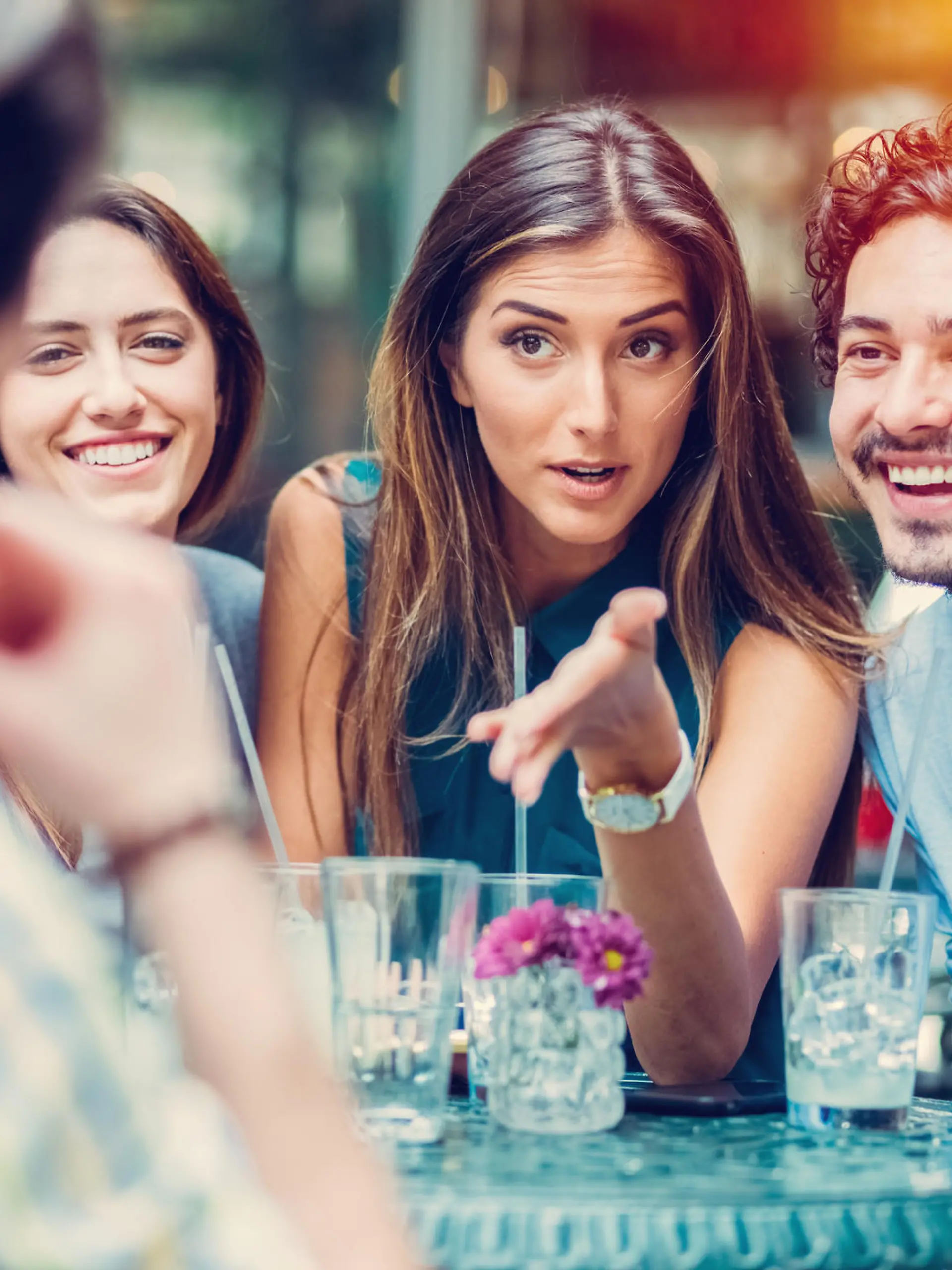 Young people gossiping at sidewalk cafe