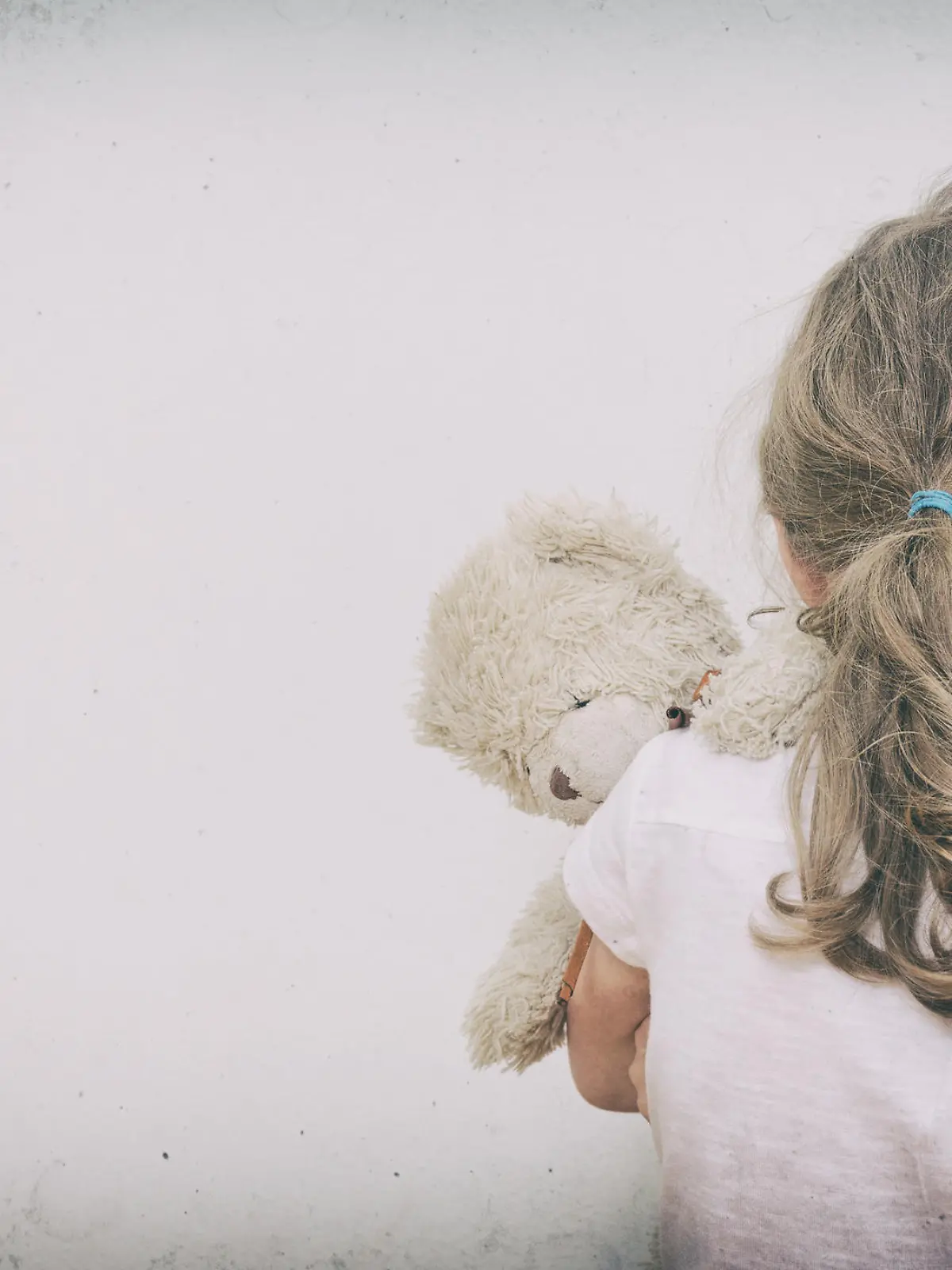 Little girl crying in the corner. Domestic violence concept.