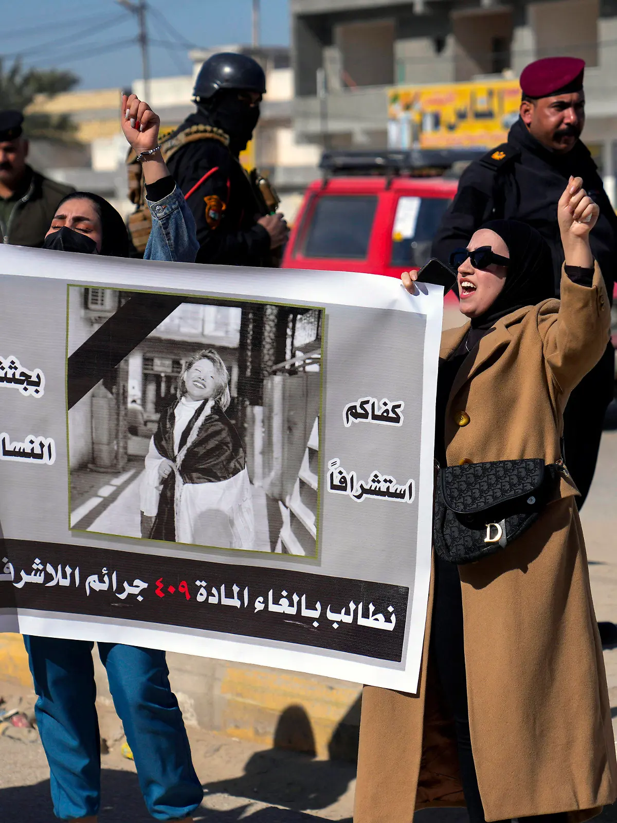 Demonstrators hold a poster with a picture of Tiba Ali, a YouTube star who was recently killed by her father, in Diwaniya, Iraq, Sunday, Feb. 5, 2023. Iraq's Interior Ministry spokesman Saad Maan on Friday announced that Tiba Ali was killed by her father on Jan. 31, who then turned himself into the police. (AP Photo/Hadi Mizban)