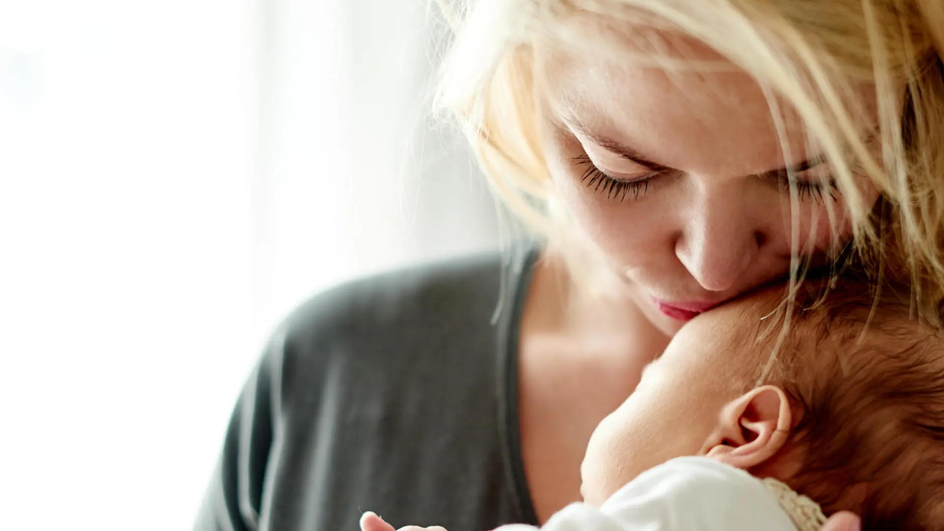Shot of a mother spending time with her newborn baby