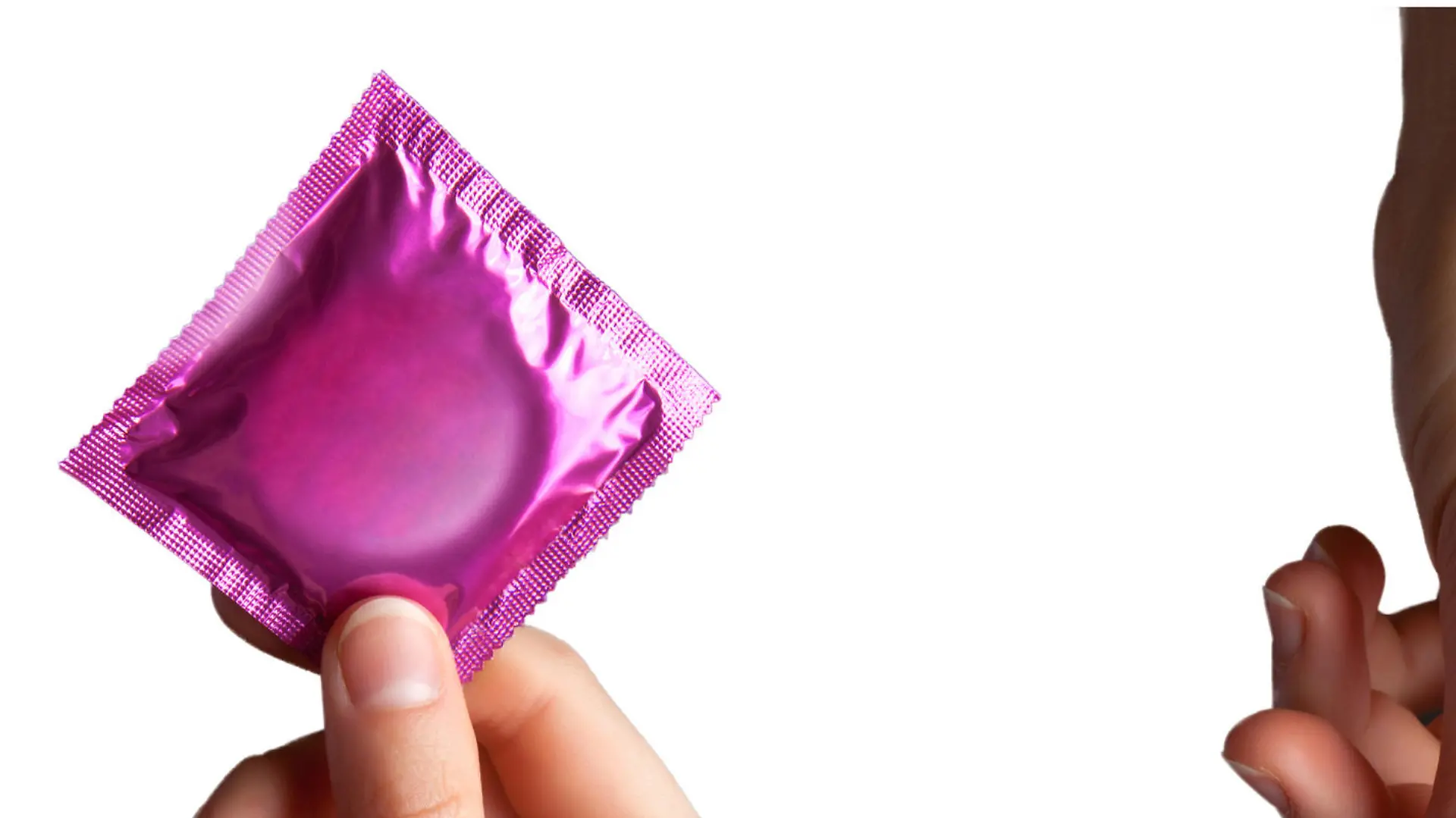 set of colored condom in female hand isolated on a white background
