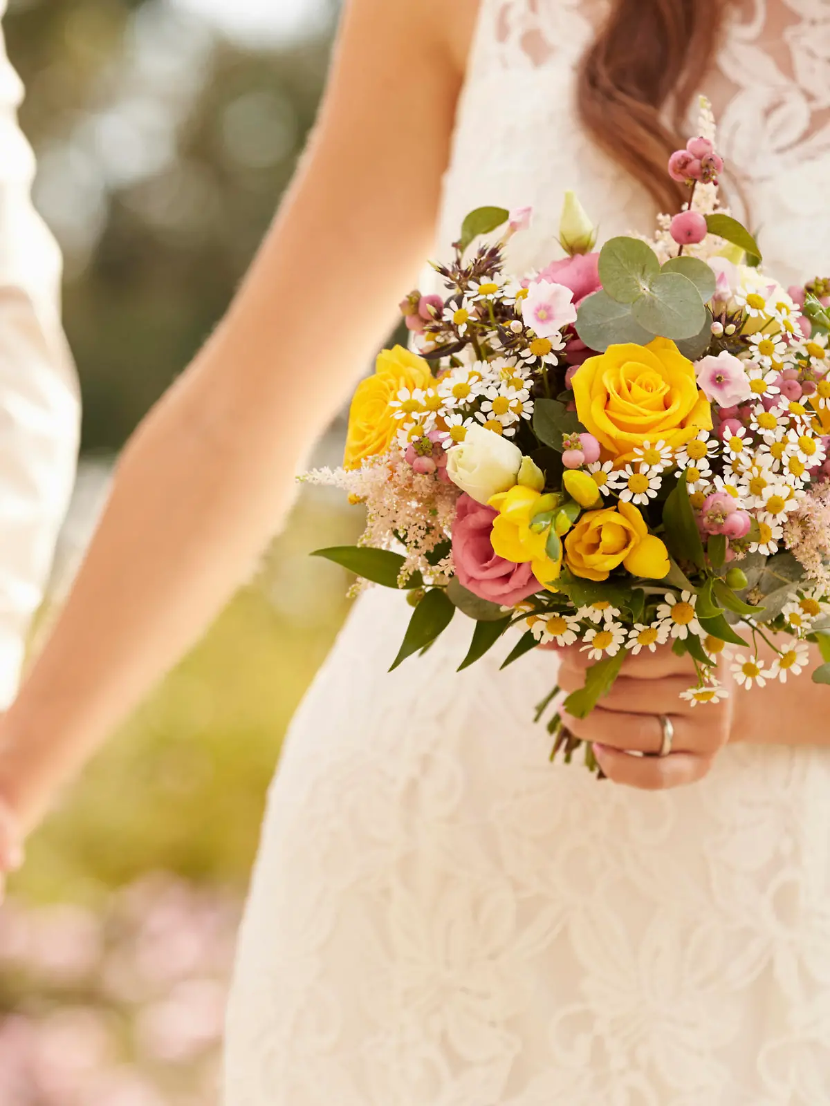 Close Up Of Couple At Wedding Holding Hands