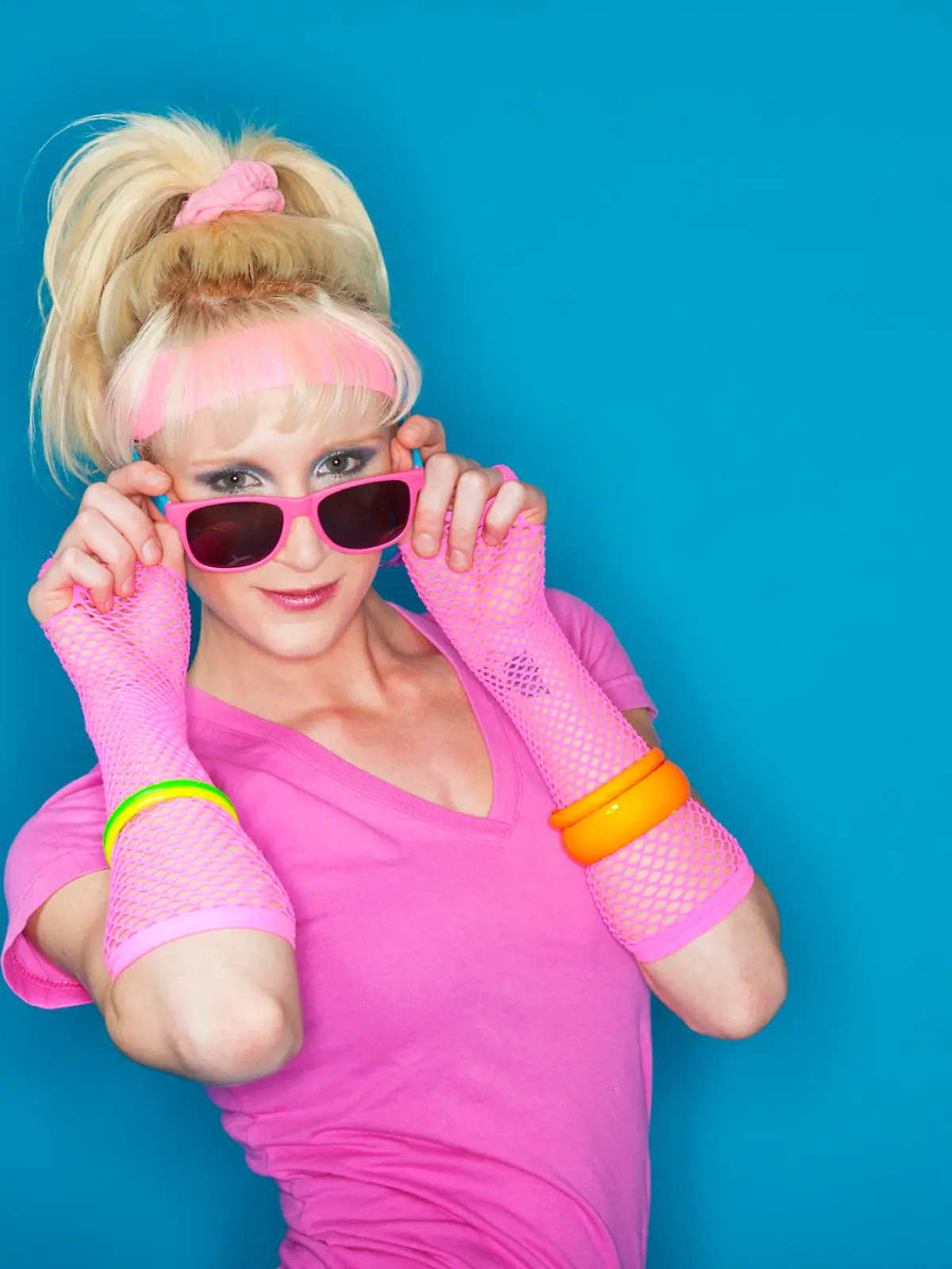 A 1980's styled blonde girl looking at the camera