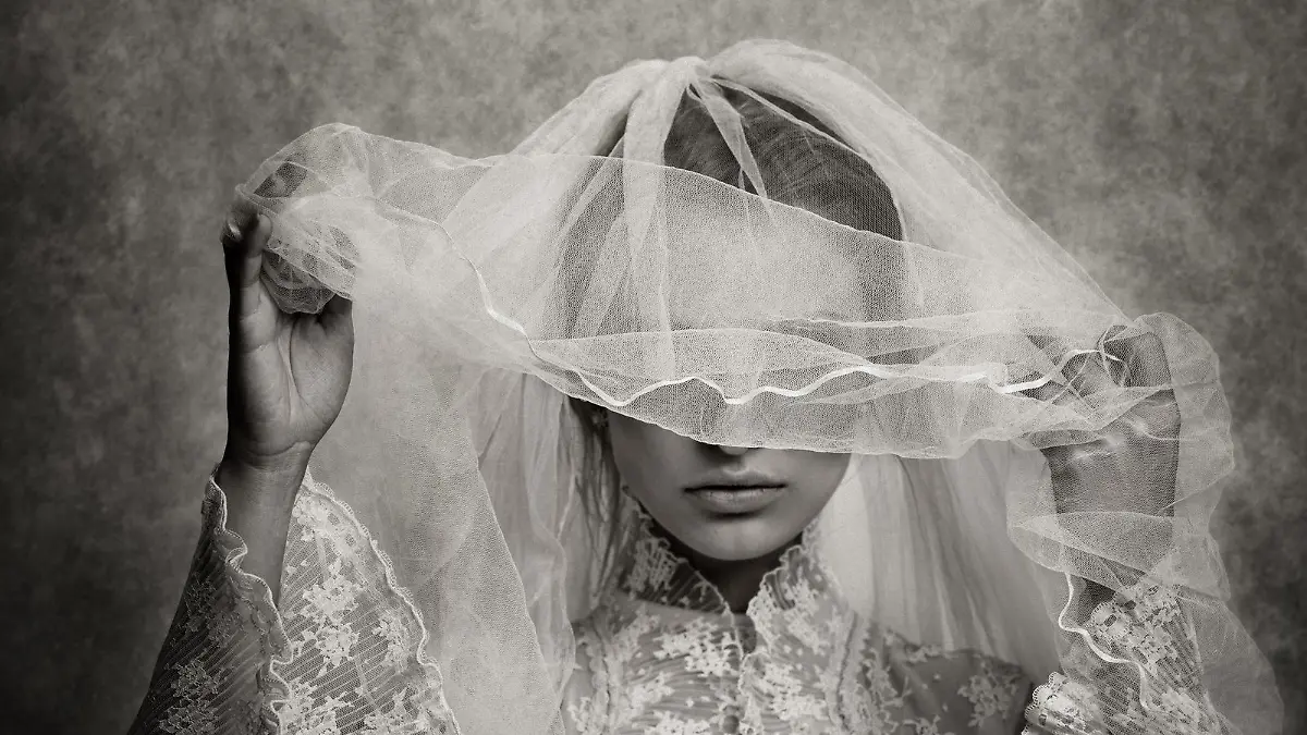 ghostly bride raising her veil - toned image, added grain, texture, vignetting