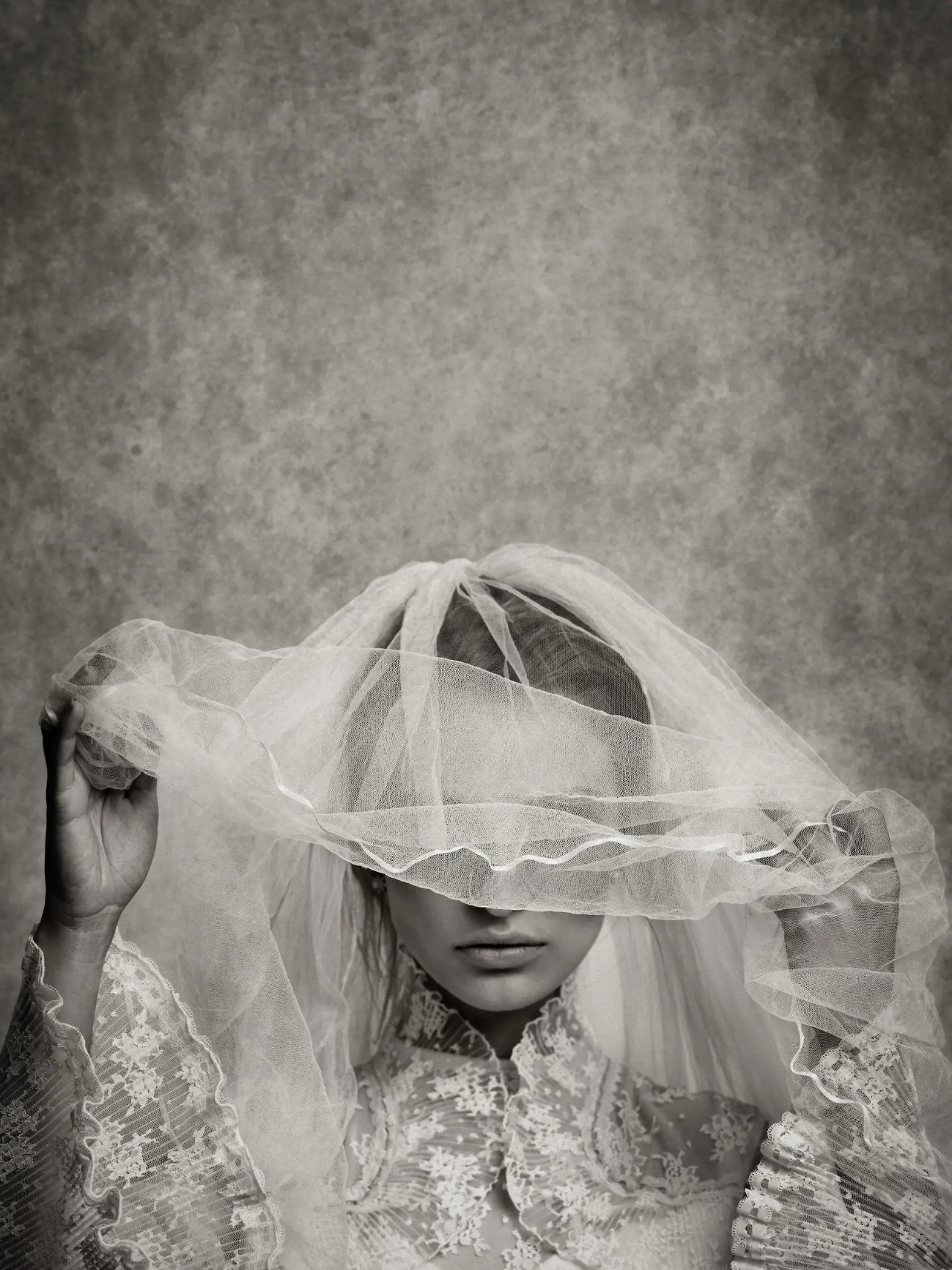 ghostly bride raising her veil - toned image, added grain, texture, vignetting