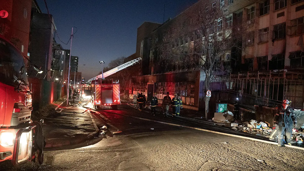 Fire fighters work at the scene of a deadly blaze in the early hours of the morning, in Johannesburg, South Africa August 31, 2023. REUTERS/Shiraaz Mohamed