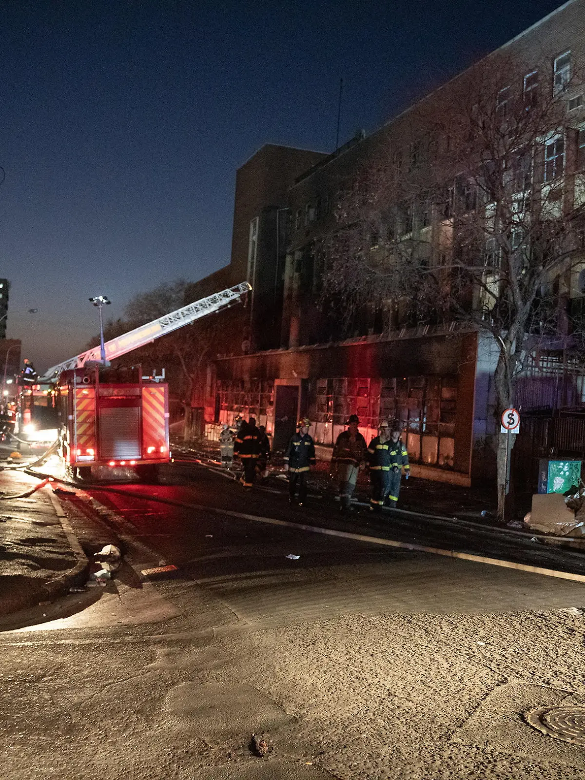 Fire fighters work at the scene of a deadly blaze in the early hours of the morning, in Johannesburg, South Africa August 31, 2023. REUTERS/Shiraaz Mohamed
