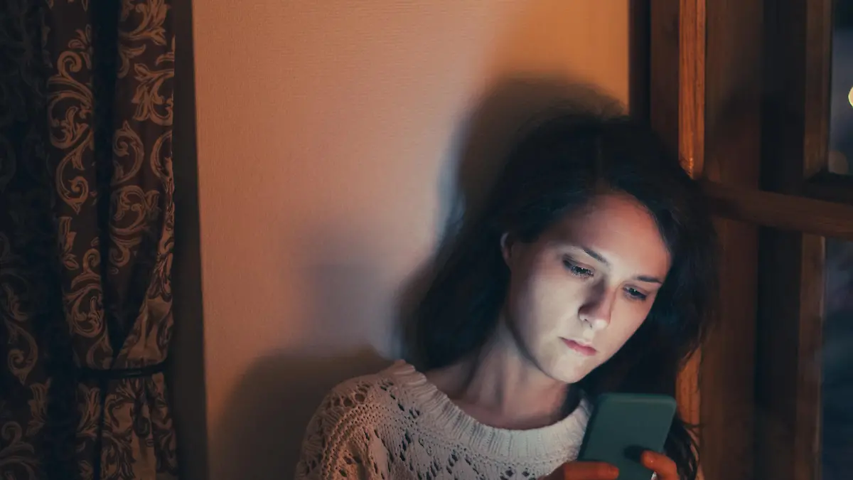 Unhappy woman at home text messaging