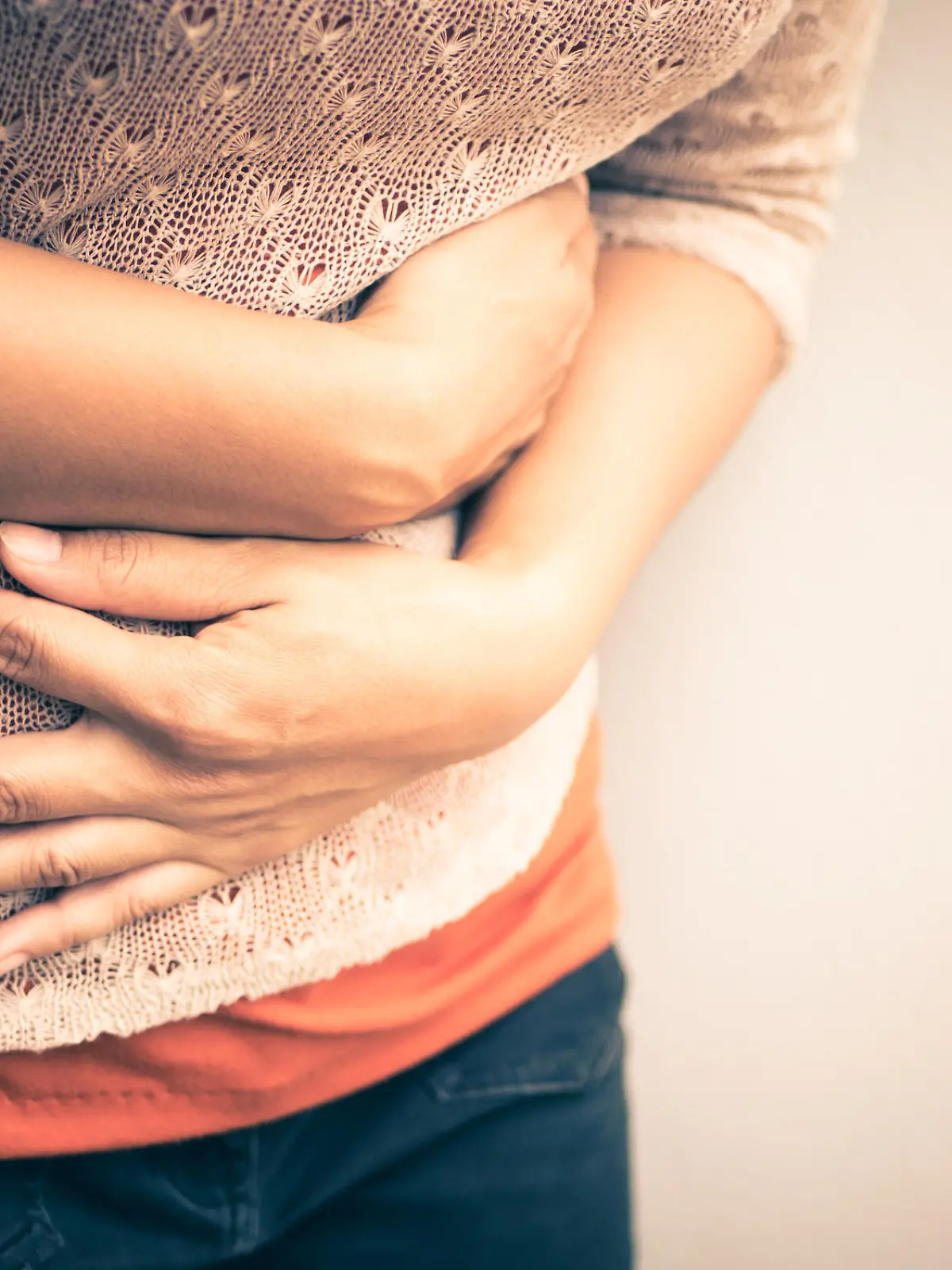 Young beautiful woman having painful stomachache.Chronic gastritis. Abdomen bloating concept.