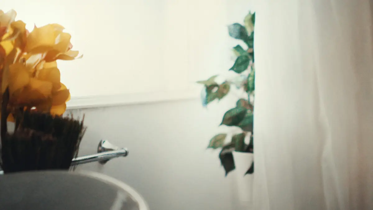 Closeup of unrecognizable 20's woman taking a morning shower. Her thigh, waist and a bit of her hand is visible only in the right hand part of the frame. Lit by natural morning light.