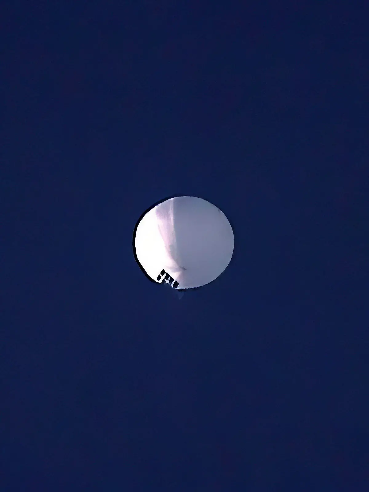 ADDS PENTAGON RESPONSE THAT IT WOULD NOT CONFIRM - A high altitude balloon floats over Billings, Mont., on Wednesday, Feb. 1, 2023. The U.S. is tracking a suspected Chinese surveillance balloon that has been spotted over U.S. airspace for a couple days, but the Pentagon decided not to shoot it down due to risks of harm for people on the ground, officials said Thursday, Feb. 2, 2023. The Pentagon would not confirm that the balloon in the photo was the surveillance balloon. (Larry Mayer/The Billings Gazette via AP)
