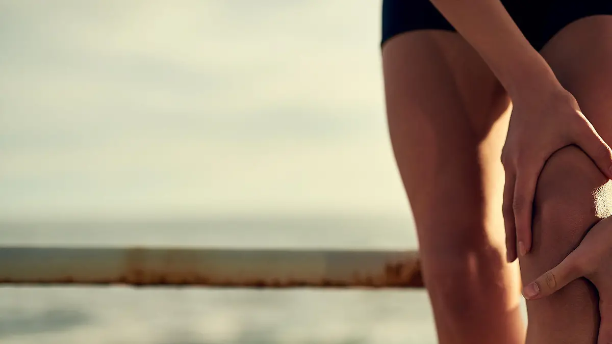 Shot of a young sporty woman holding on to her injured knee