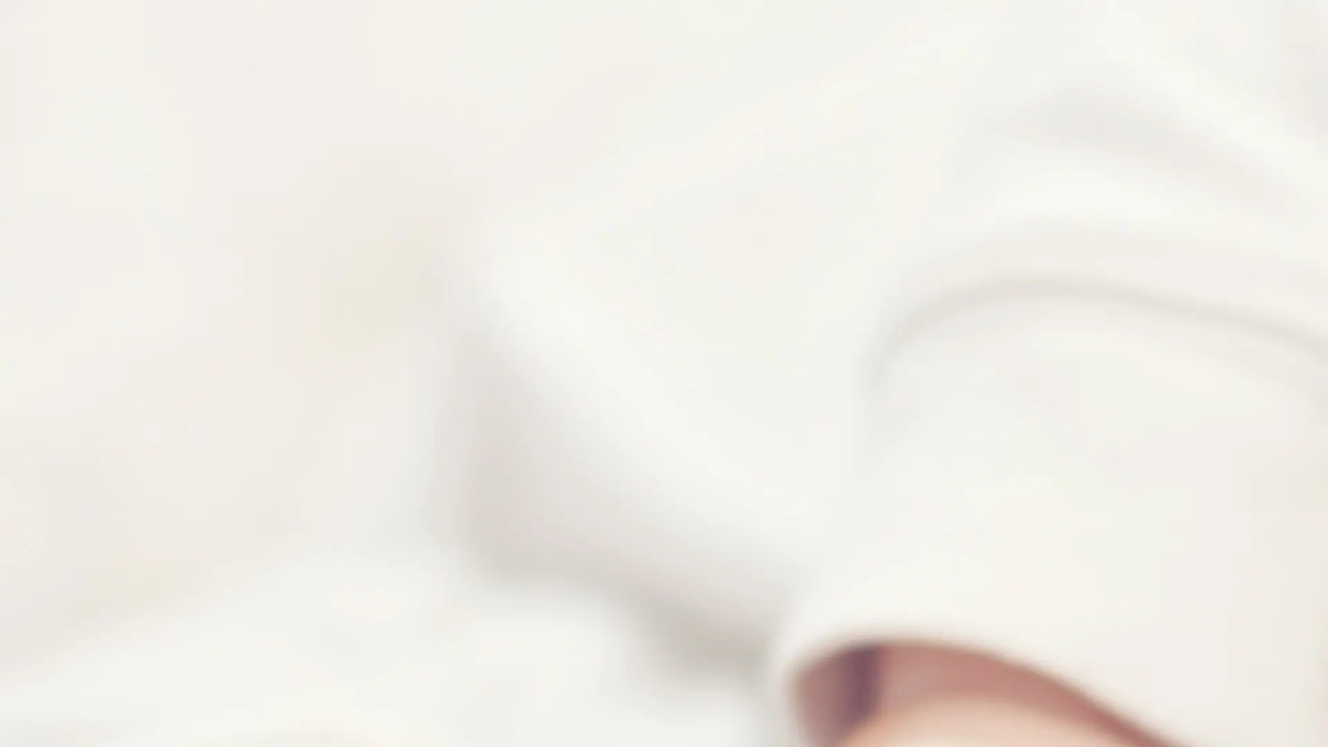 close-up portrait of a beautiful sleeping baby on white