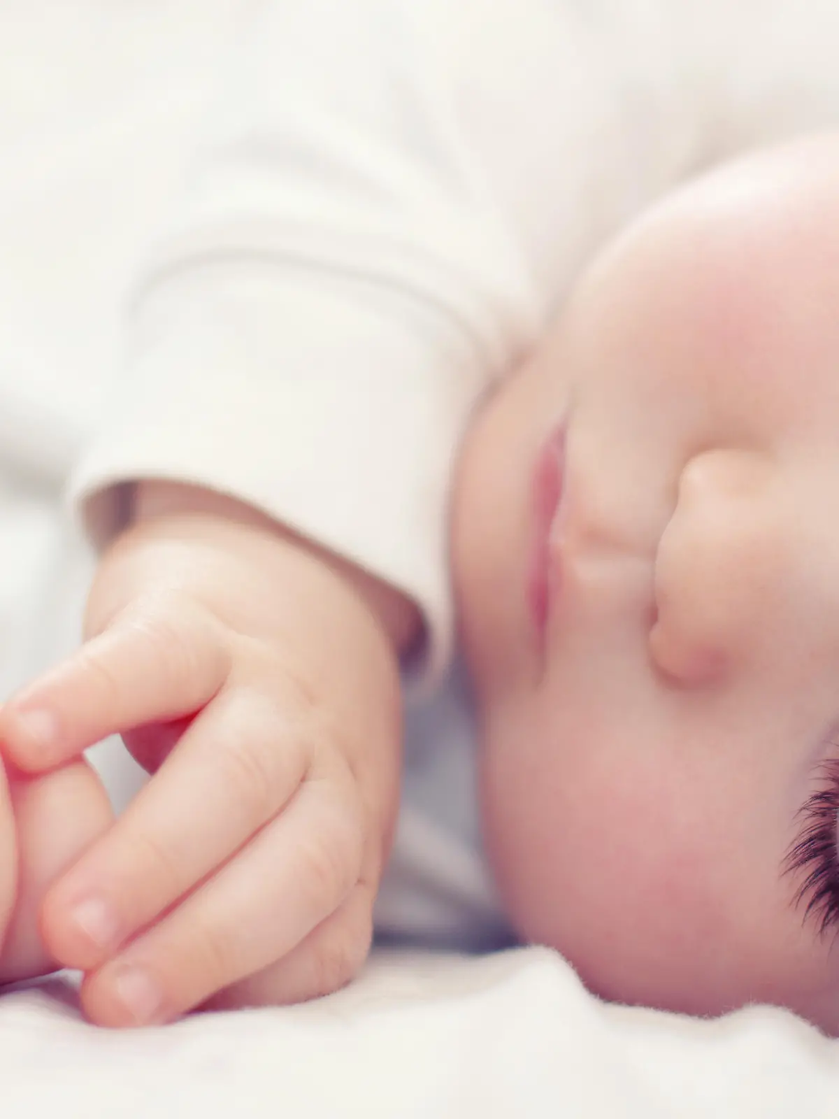 close-up portrait of a beautiful sleeping baby on white