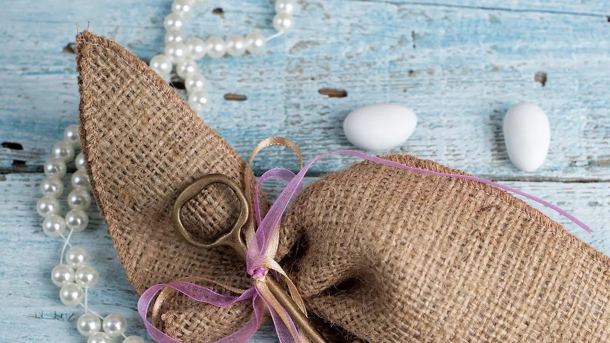 Burlap wedding favor on old wooden table