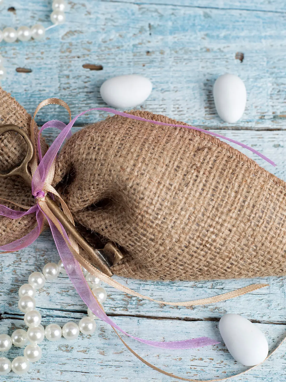 Burlap wedding favor on old wooden table
