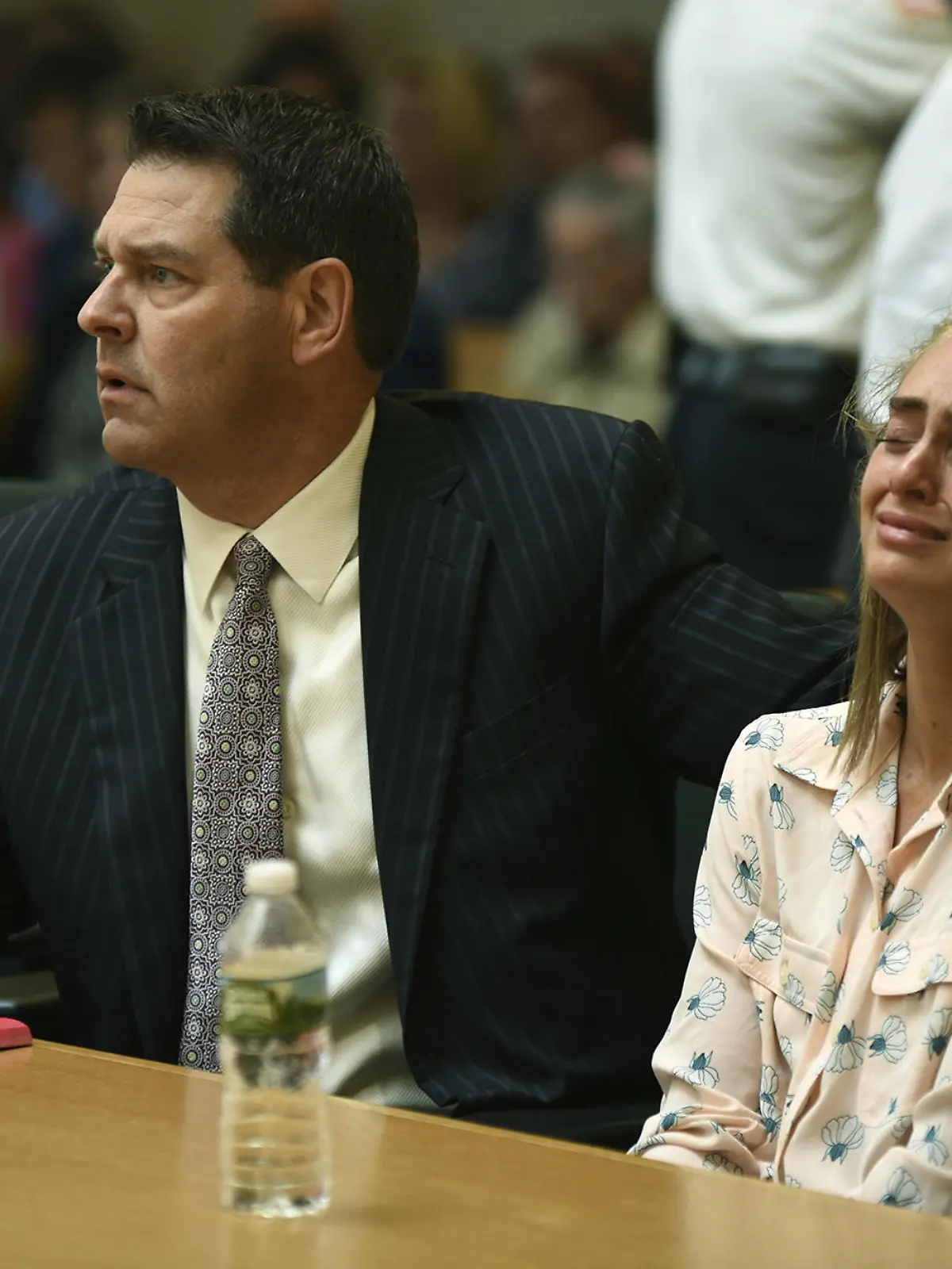 Michelle Carter, right, seated with her attorneys Cory Madera, left, and Joseph Cataldo reacts as she listens to Judge Lawrence Moniz before he finds her guilty of involuntary manslaughter in the suicide of Conrad Roy III, Friday, June 16, 2017, in Bristol Juvenile Court in Taunton, Mass. (Glenn C.Silva/Fairhaven Neighborhood News, Pool) |