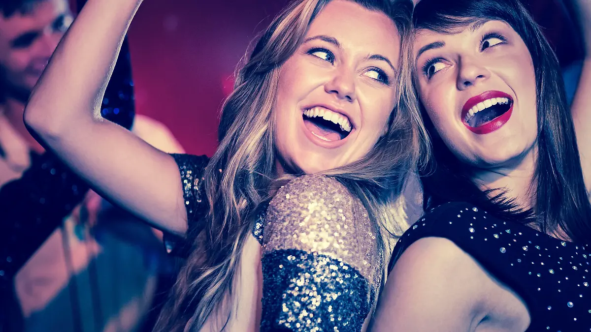 Happy friends having fun together at the nightclub