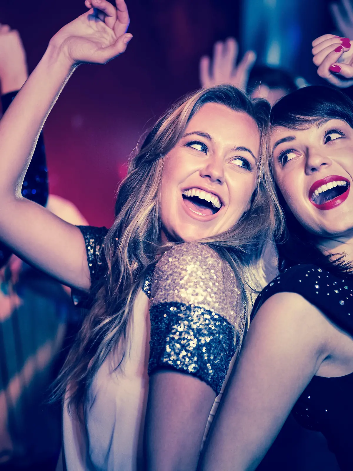 Happy friends having fun together at the nightclub