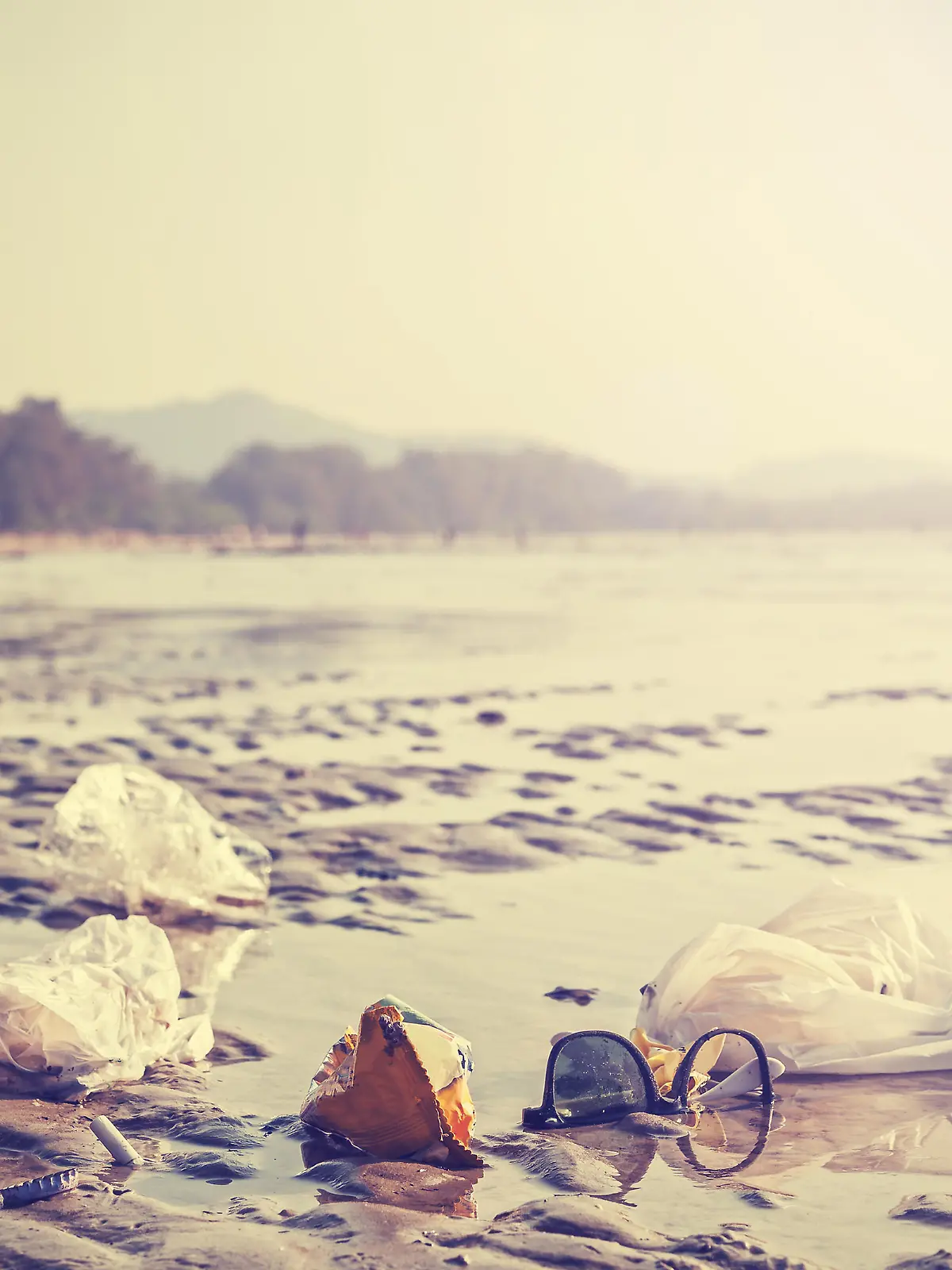 Garbage on a beach left by tourists, environmental pollution concept picture.