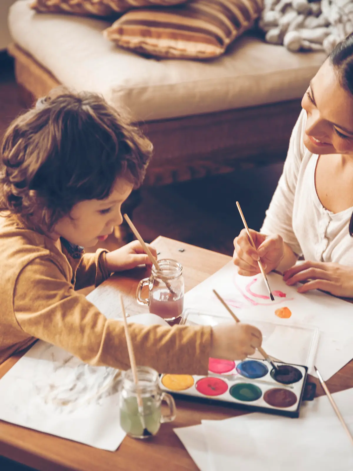 Close up of a mother painting with son