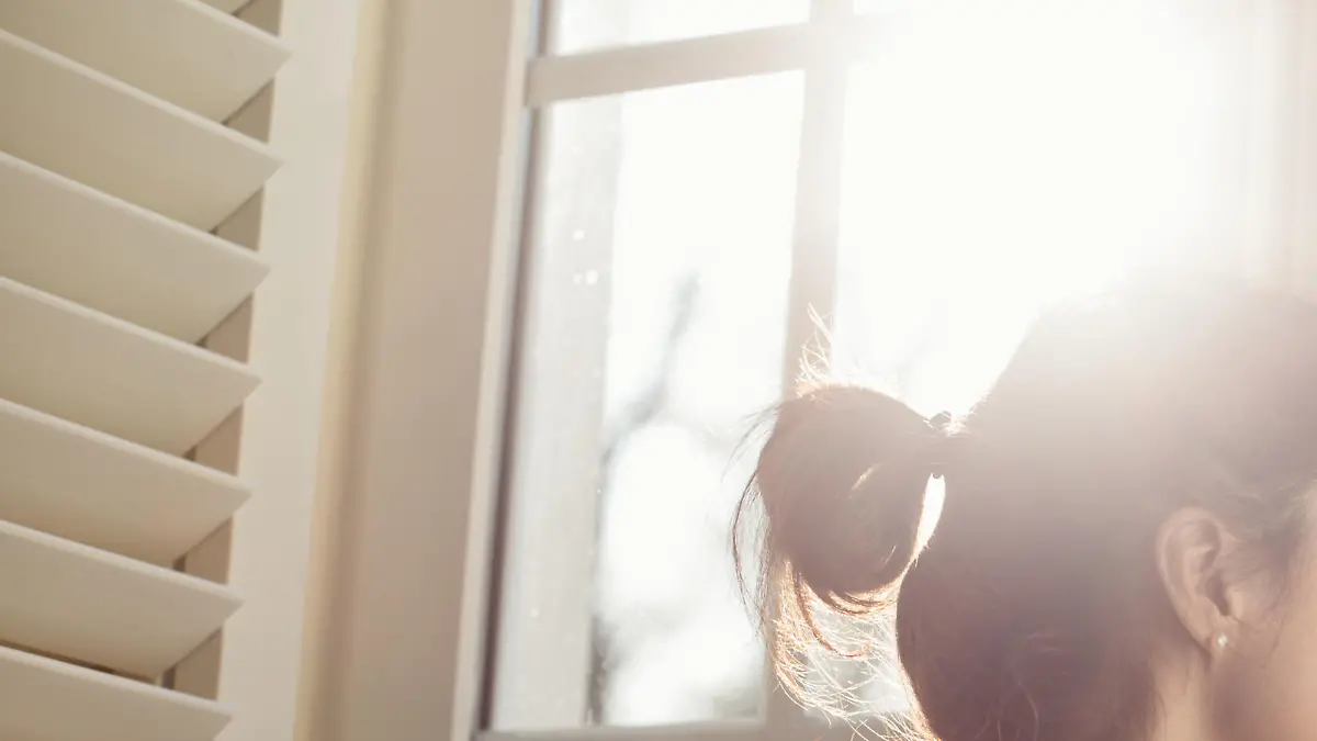 Thoughtful woman at home - copyspace