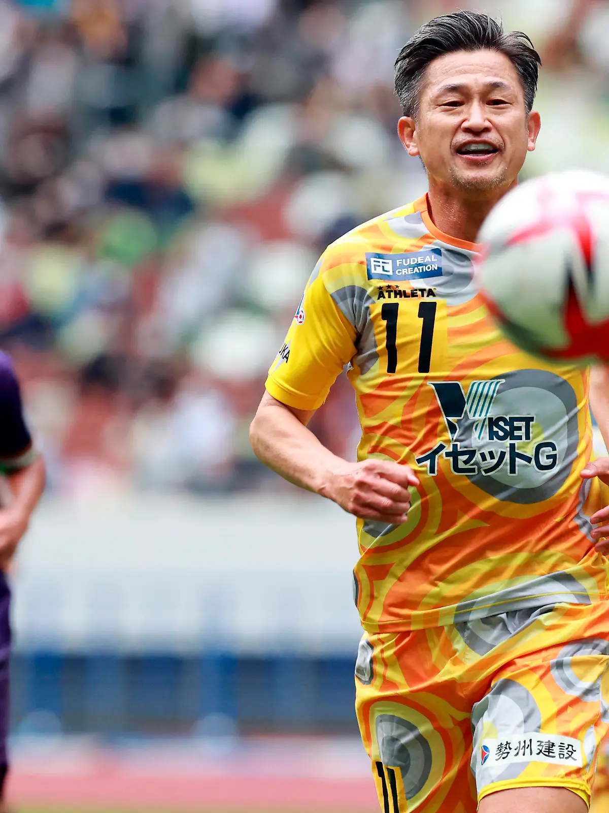 Kazuyoshi Miura, Japanese footballer who belongs to Suzuka Point Getters of Japan Football League (JFL), comes in midway during JFL football match against Criacao Shinjuku at National Stadium in Shinjuku Ward, Tokyo on October 9, 2022. 55-year-old King Kazu played for the Japan national team from 1990 to 2000, and holds the records for being the oldest goal scorer in the J-League, the footballer with the world's longest professional career, and, as of 2022, is the oldest professional footballer in the world at 55.( The Yomiuri Shimbun via AP Images )