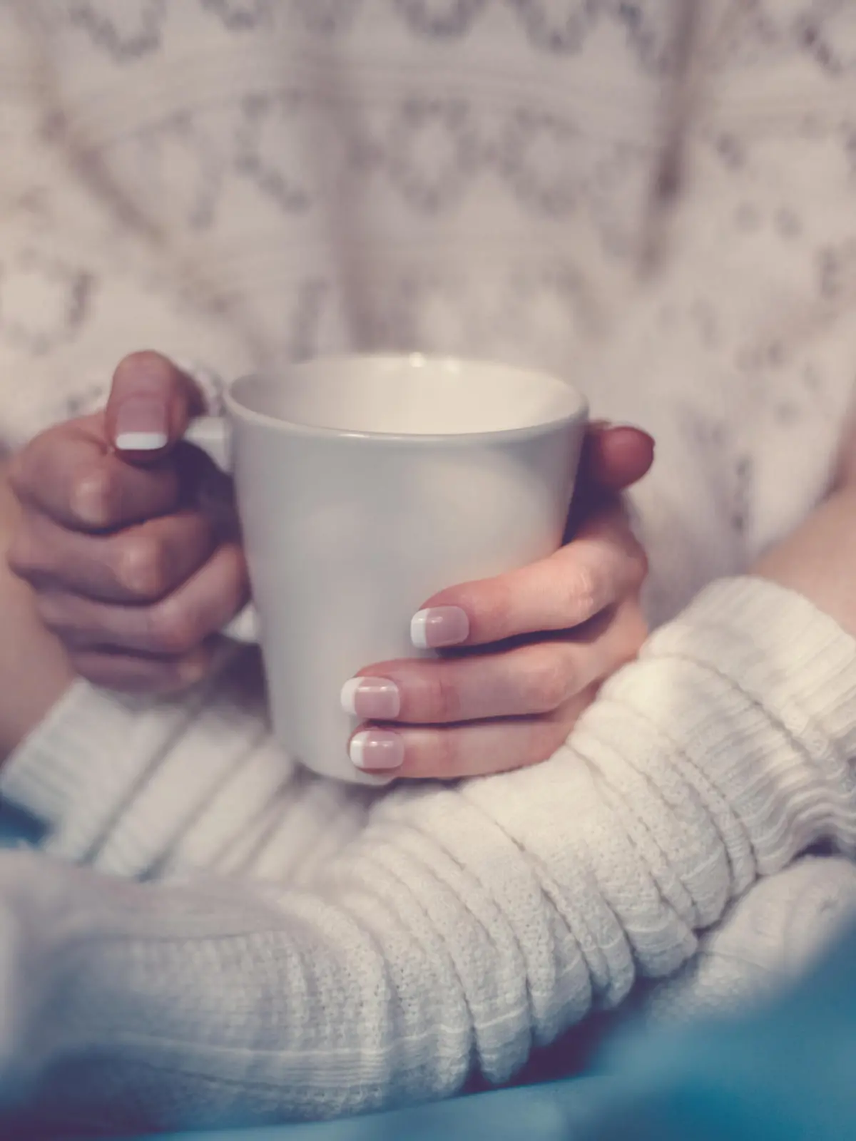Girl with coffee cup in bed