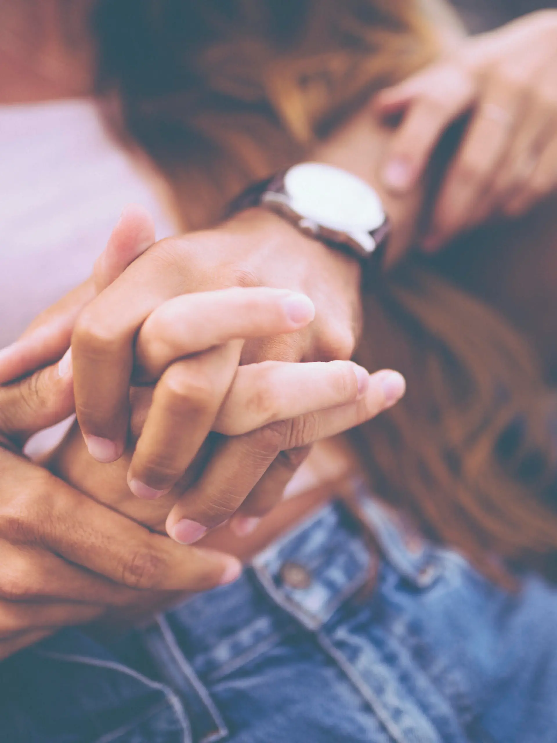 Cropped image of young couple holding hands with a vintage developing style