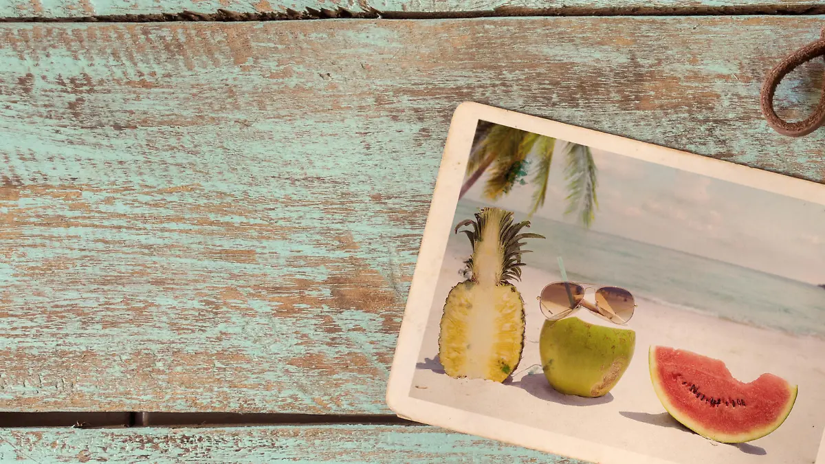 Photo album of journey honeymoon trip in summer on wood table. instant photo of retro camera - vintage and retro style