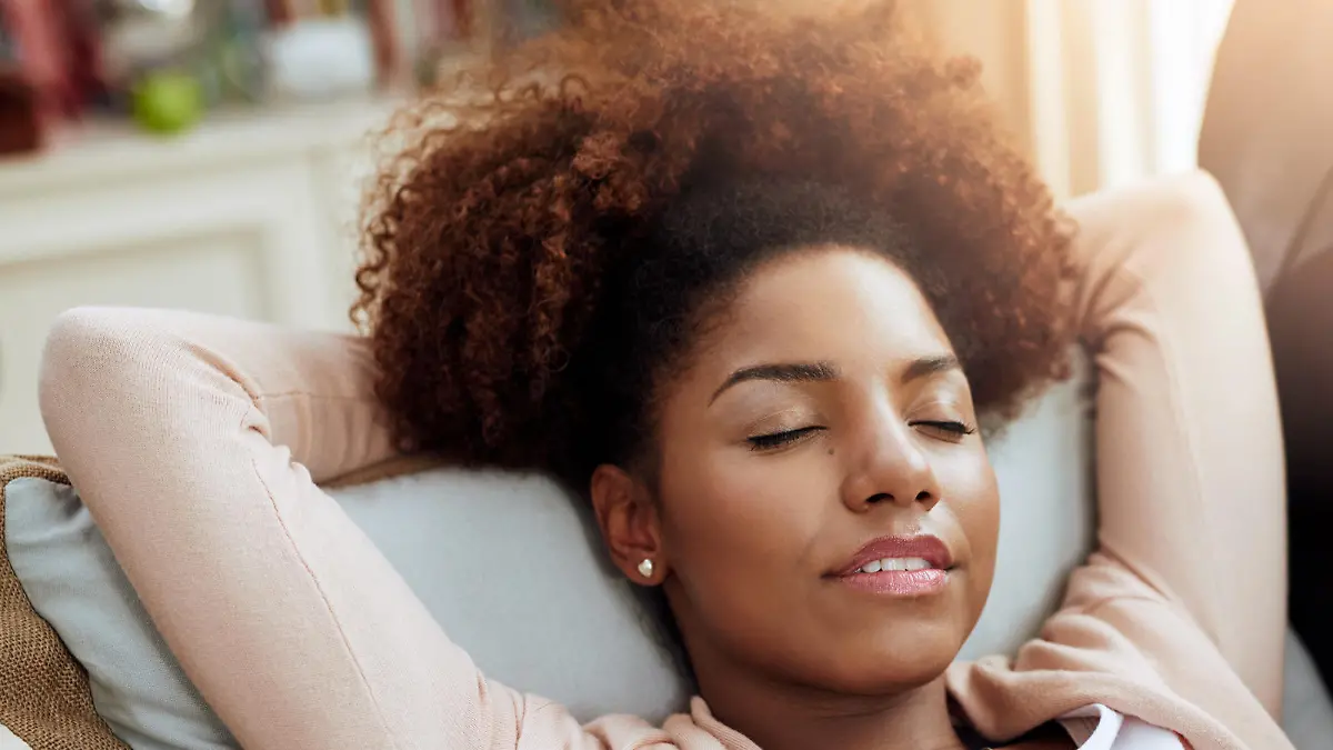 Shot of a young woman relaxing on the sofa at home