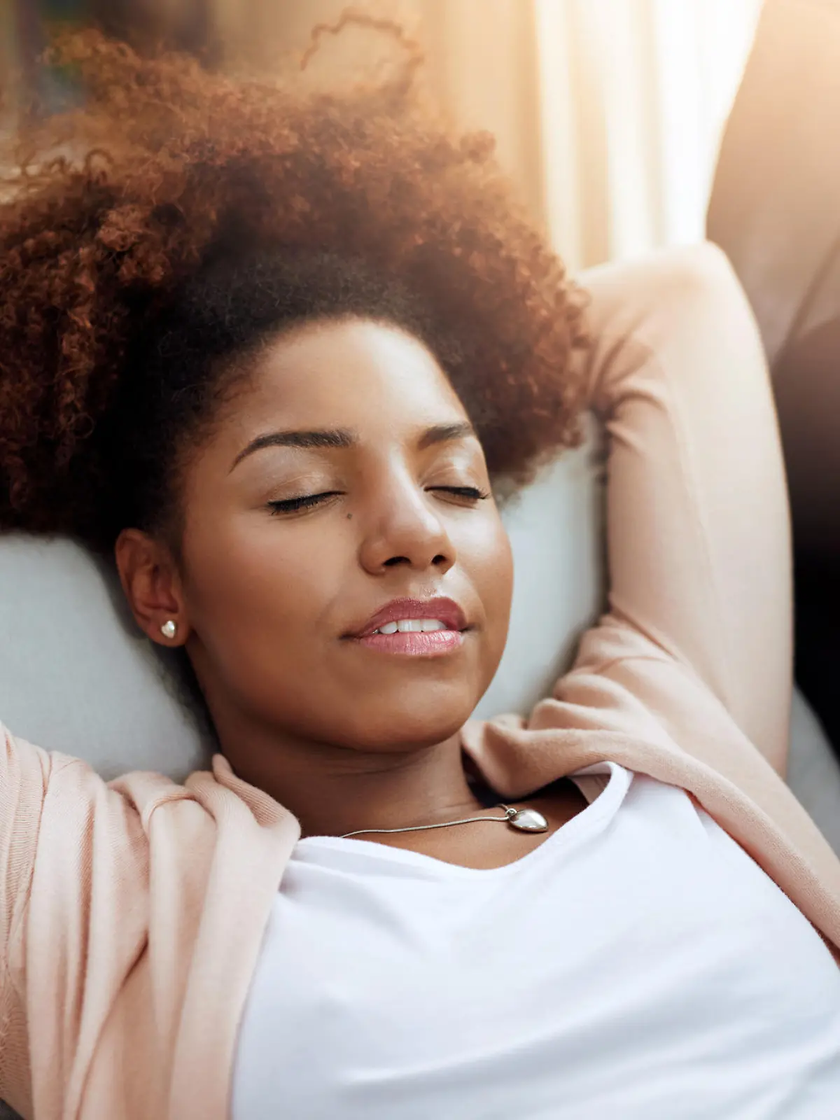 Shot of a young woman relaxing on the sofa at home