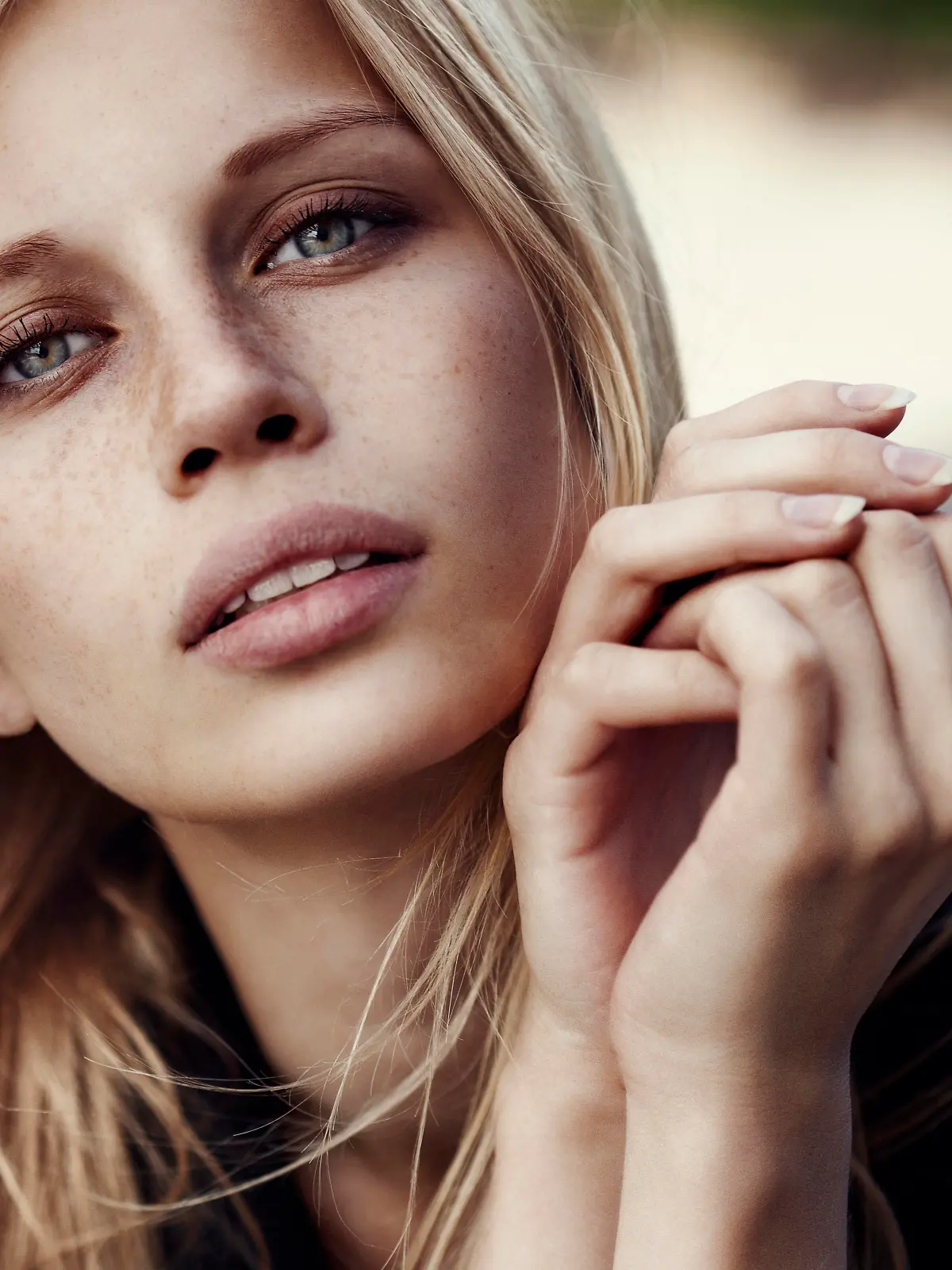 Studio shot of young beautiful woman outdoors wearing watches