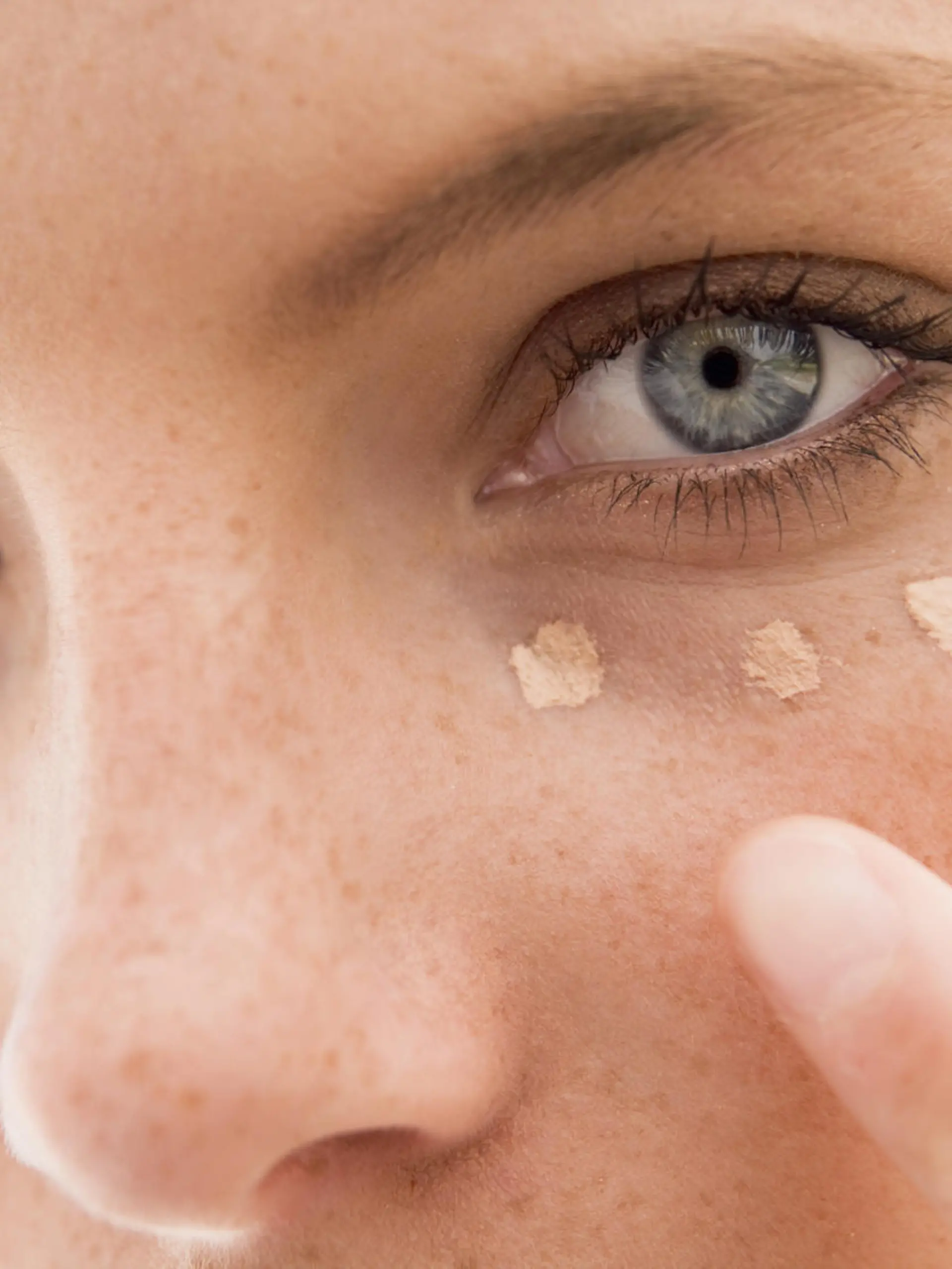 Close up of woman putting on make up