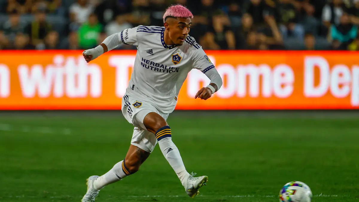 LA Galaxy defender Julian Araujo (2) drives the ball against the Los Angeles FC during the first half of an MLS playoff soccer match on Thursday, Oct. 20, 2022, in Los Angeles. (AP Photo/Ringo H.W. Chiu)