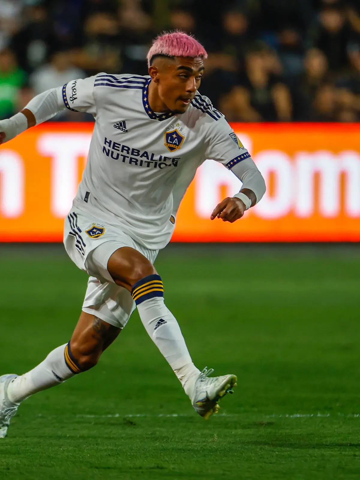 LA Galaxy defender Julian Araujo (2) drives the ball against the Los Angeles FC during the first half of an MLS playoff soccer match on Thursday, Oct. 20, 2022, in Los Angeles. (AP Photo/Ringo H.W. Chiu)