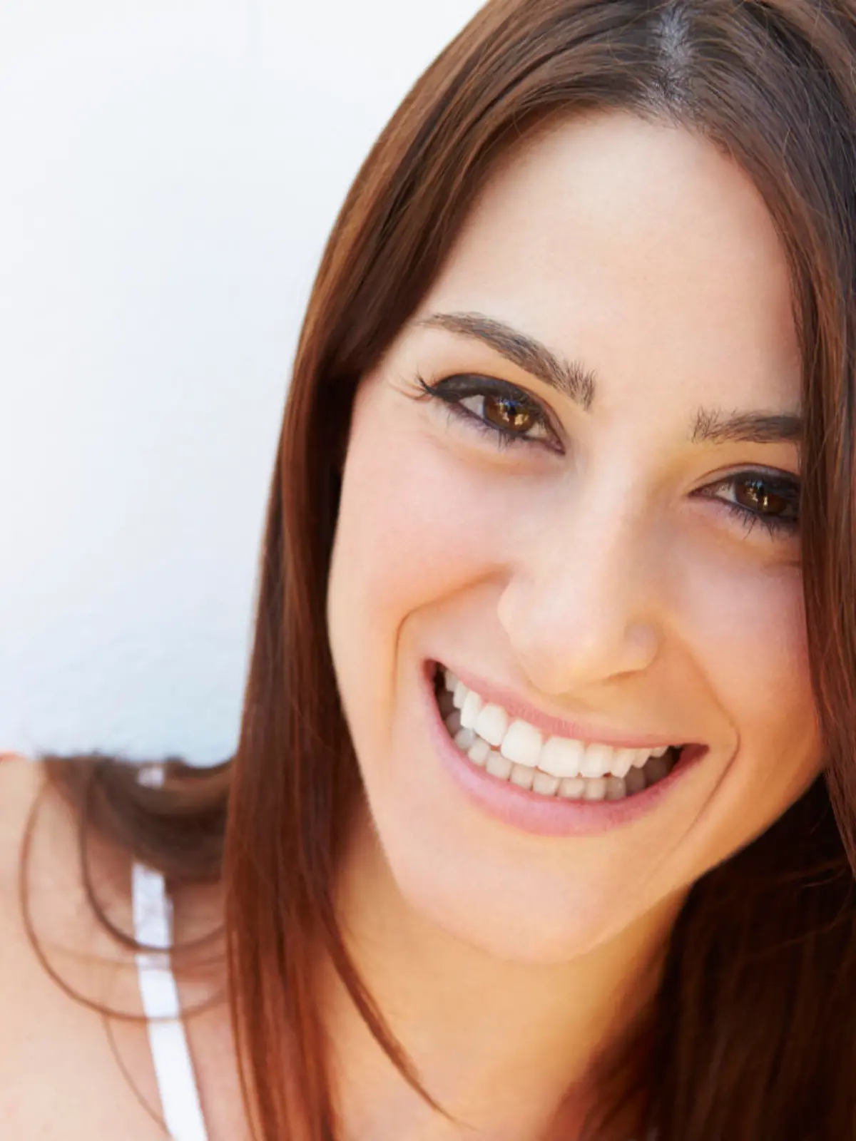 Portrait Of Pretty Young Woman Standing By Wall