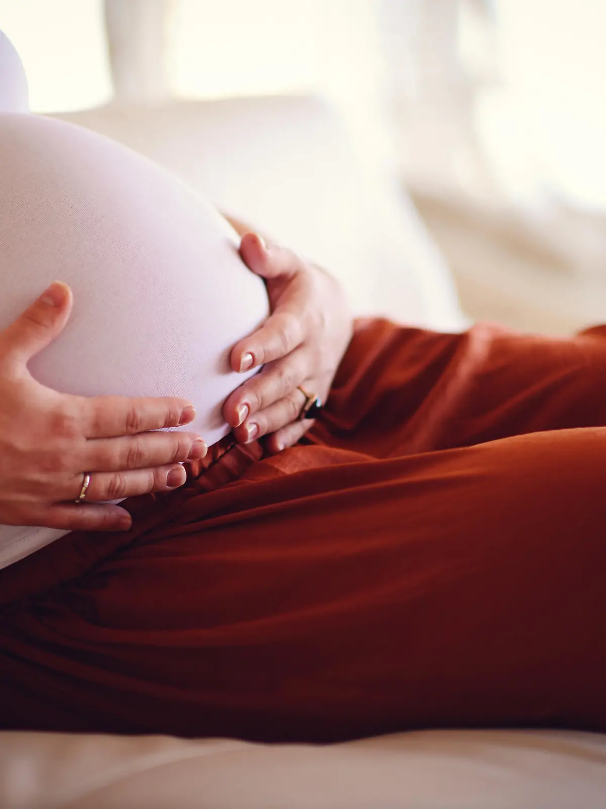 A baby bump of a pregnant woman close up