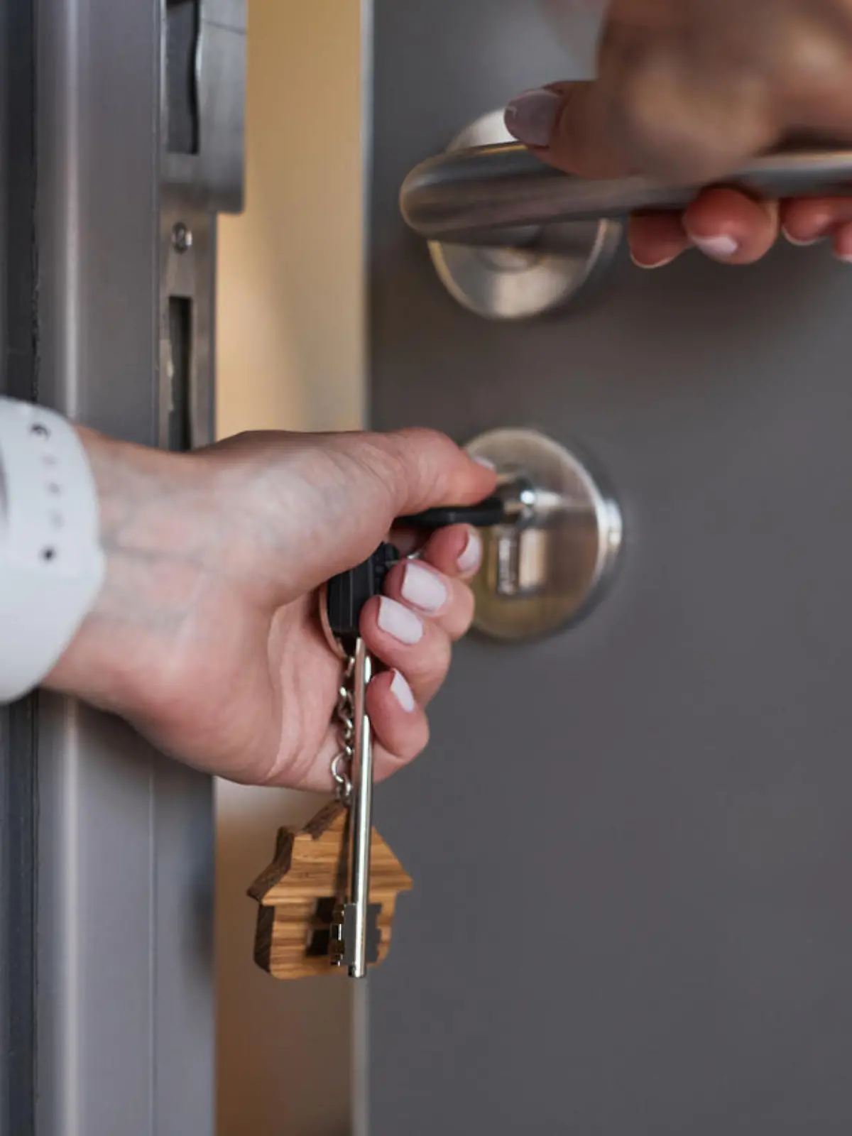 Close up of unrecognizable man opening door to new house, copy space