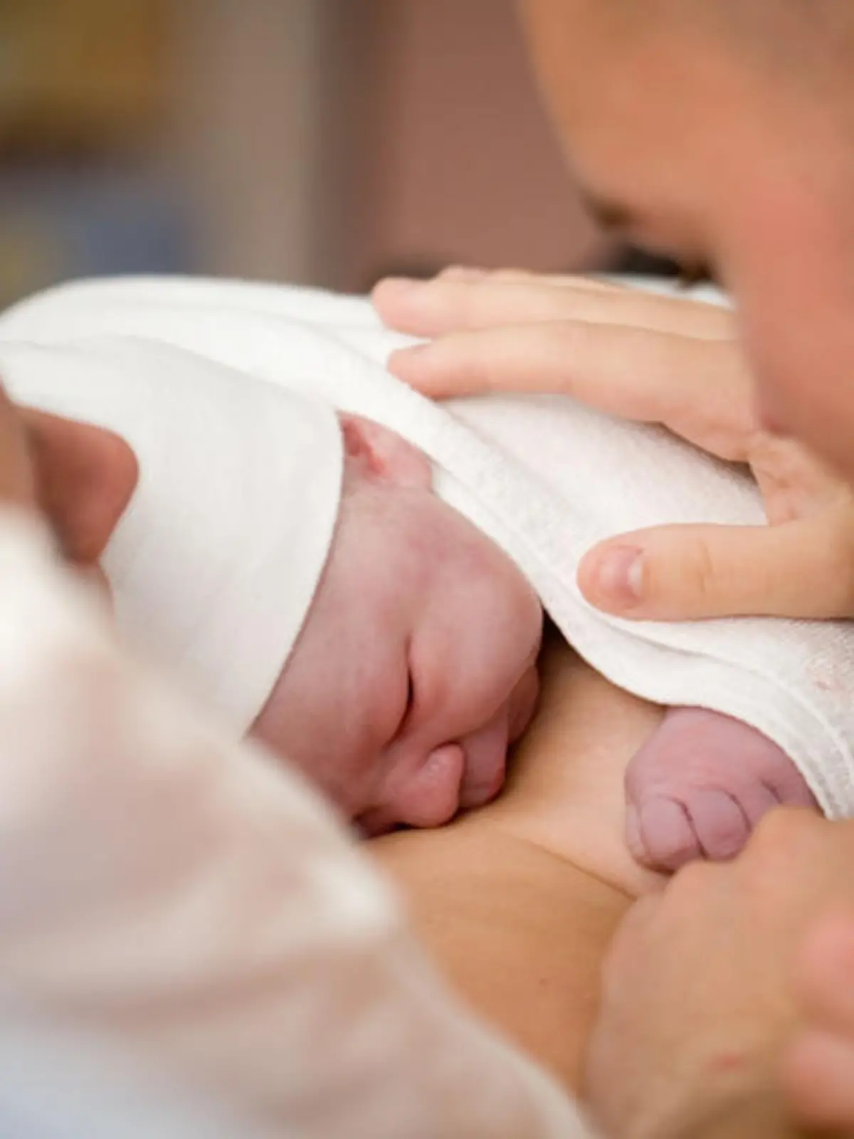 Newborn baby girl right after delivery, shallow focus